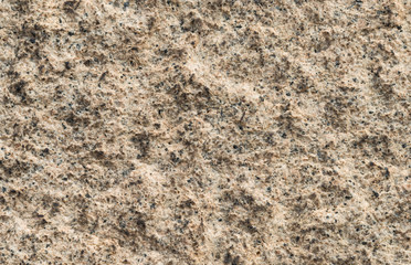 Yellowish granite wall with quarts and rough surface as background