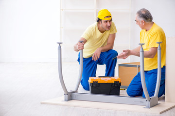 Two contractors carpenters working indoors