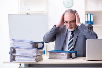 Aged male employee unhappy with excessive work