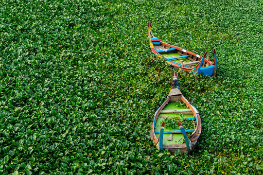 The wooden boats at U Bein Bridge, the oldest and longest teakwood bridge in the world across the Taungthaman Lake, Amarapura, Myanma