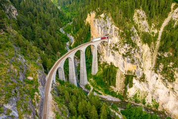 Photo sur Plexiglas Viaduc de Landwasser Train sortant d& 39 une montagne à un viaduc célèbre en Suisse