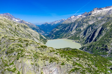 Aerial view over a mountain lake at Grimsel pass in Switzerland