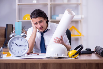 Young male architect working in the office