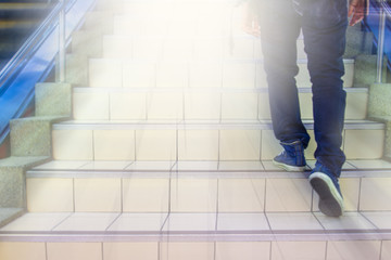 Fototapeta na wymiar Pathway to success concept a man walk on the stair with space area for write some text on a blue background meaning walk to success concept