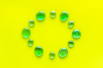 Bright stones on yellow background top view mock up