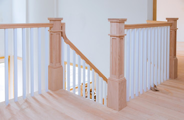 Hallway interior with hardwood floor view of wooden stairs.