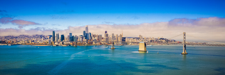 Panoramic San Francisco skyline and the Bay bridge - obrazy, fototapety, plakaty
