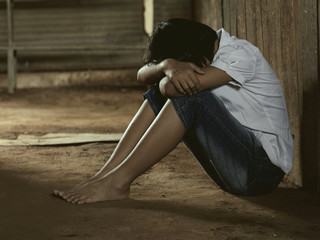 Young girl sitting on the floor, concept of stress or traumatized