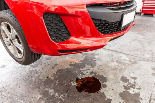 Concept Of Car Oil Leak Depicted With Red Vehicle And Puddle Of Oil Underneath