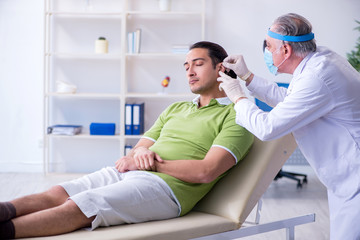 Male patient visiting doctor otolaryngologist