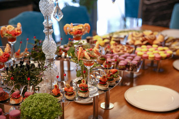 blue chairs long fancy table fulfilled with candies and desserts