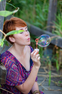 WOMAN SITTING ON A GANGWAY WITH BUBBLES.