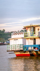 the activity of Mahakam river. tugboat dragging barge of coal and wooden boat which take passenger to the remote area of upper Mahakam, Borneo, Indonesia