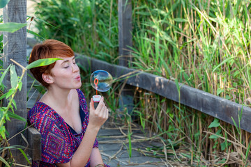 WOMAN SITTING ON A GANGWAY WITH BUBBLES.