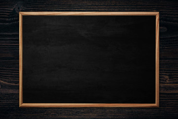 Abstract blackboard or chalkboard with frame on wooden background.