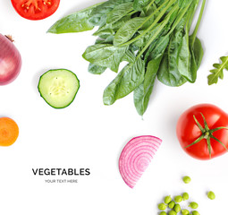 Creative layout made of spinach, tomato, cucumber, carrot and onion. Flat lay. Food concept. Lemon...
