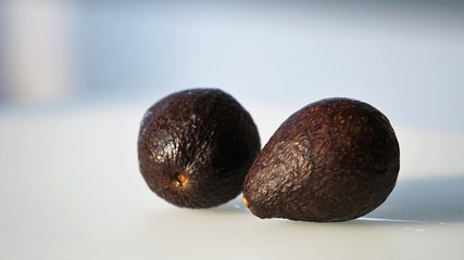 close up on two avocados on light background