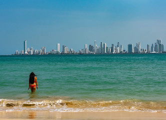 A girl is getting in to the see front of Cartagena coastline