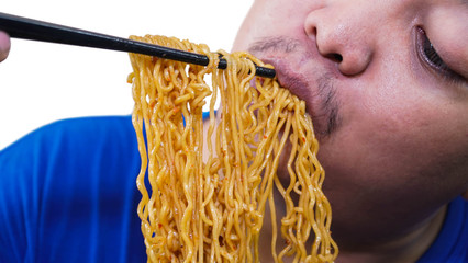 fat or overweight Asian man eat a lot of instant noodles or pasta with chopsticks isolated