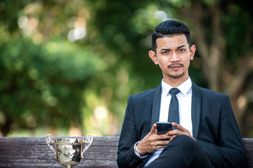Malay Businessman Texting on his Smartphone
