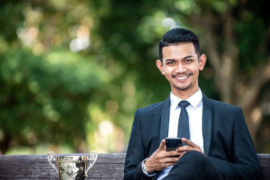 Malay Businessman Texting On His Smartphone