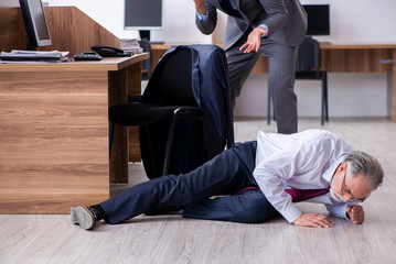 Male employee suffering from heart attack in the office