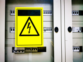 main master electrical fuse switches with neon yellow dangerous warning sign on it