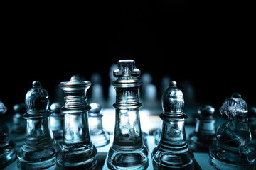 The concept of business competition: Close-up of a businessman holding a glass chess