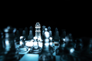 The concept of business competition: Close-up of a businessman holding a glass chess