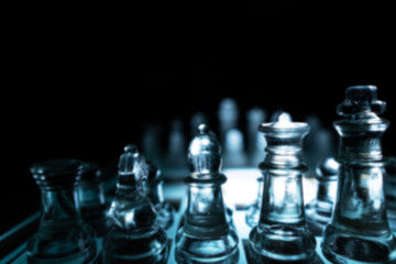 The concept of business competition: Close-up of a businessman holding a glass chess