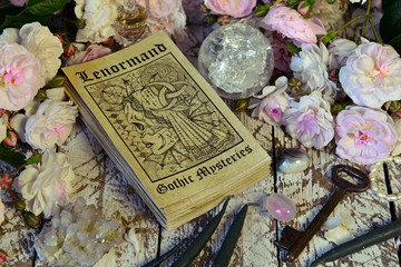 Still life with Lenormand tarot cards deck and roses.