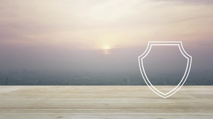 Airplane with shield flat icon on wooden table over aerial view of cityscape at sunset, vintage style, Business travel insurance and safety concept