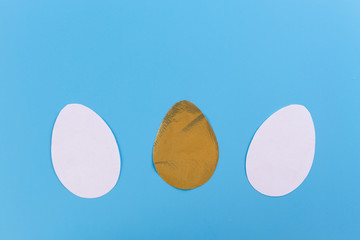 Golden eggs on blue background