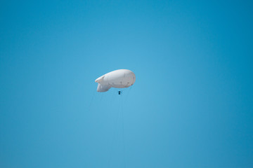 white airship in the blue sky. copy space