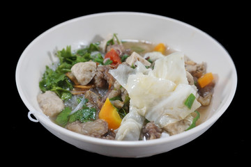 Soup in white bowl (beef, meatballs, vegetables, vermicell) indonesian food, isolates on black background