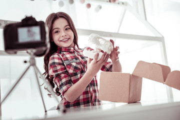 Happy nice girl showing a dinosaur scull