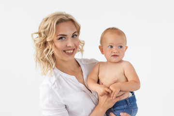 Single parent, motherhood and babyhood concept - Mother holding sweet baby girl on white background