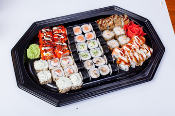 Japanese national popular cuisine. Sushi, rice and fish. Tasty, beautifully served food in a restaurant, cafe, with elements of the original design.