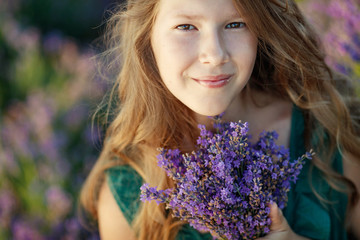 Teenager girl in a field with flowers. 