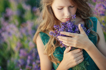 Fototapeta premium Teenager girl in a field with flowers. 