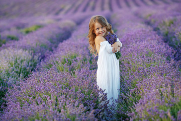 Little girl in a field with flowers. 