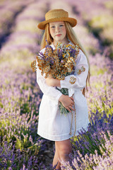 Girl with flowers. Teenager girl in a field with flowers.
