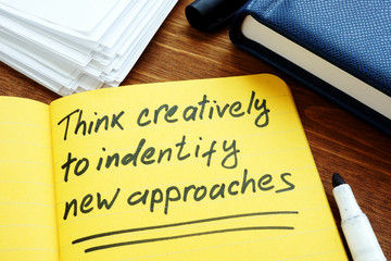 Think creatively to identify new approaches handwritten on page.