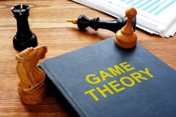 Game theory book and chess with documents.