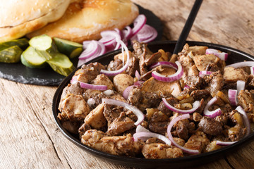 Freshly prepared Jerusalem mixed grill from chicken and offal close-up on a plate. horizontal
