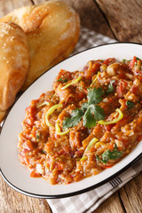 Smokey roasted eggplant mash with spices, this punjabi baingan bharta is a very popular dish in North India closeup on the plate. Vertical