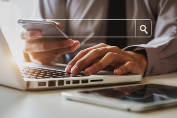 Businessman hand using laptop, tablet and smartphone  in office. Digital marketing media mobile app...