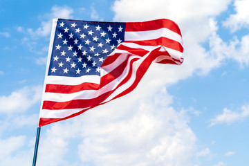 American flag waving in the wind against blue sky