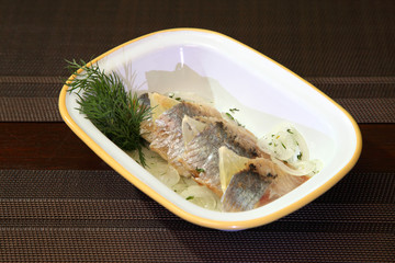 Herring fillet with onion lemon and dill.
