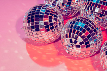 disco balls for decorationof a party on  pink  background
